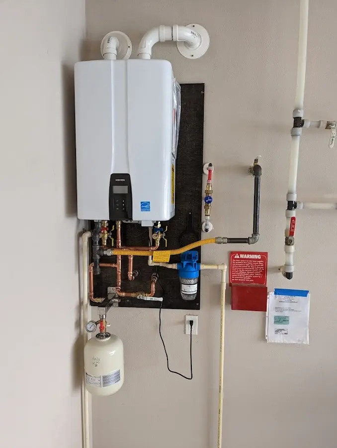 Professional plumber installing copper piping in a New Hope home